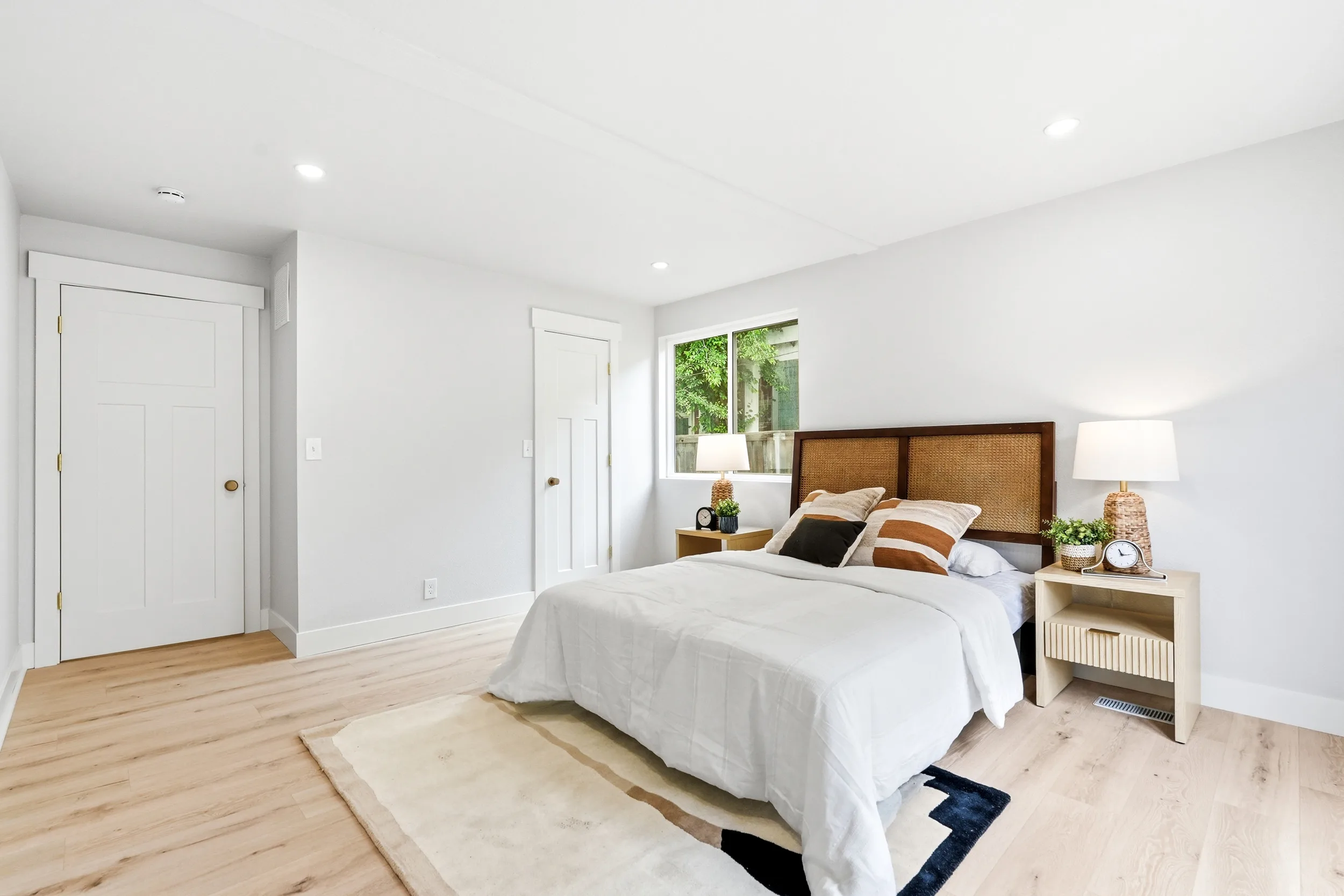 Bedroom with new flooring and recessed lighting