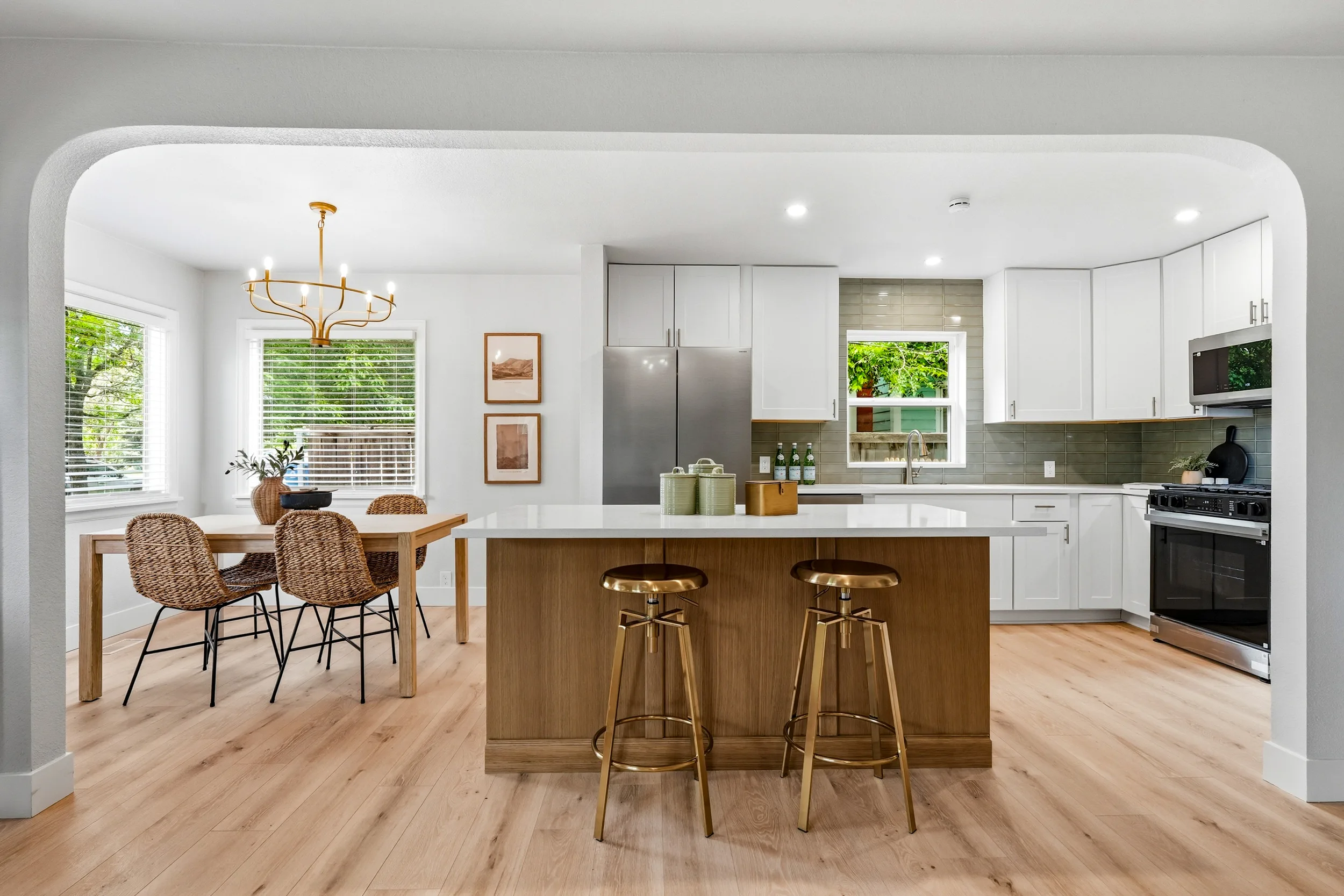 The kitchen and dining area seen through one of the home's arched openings